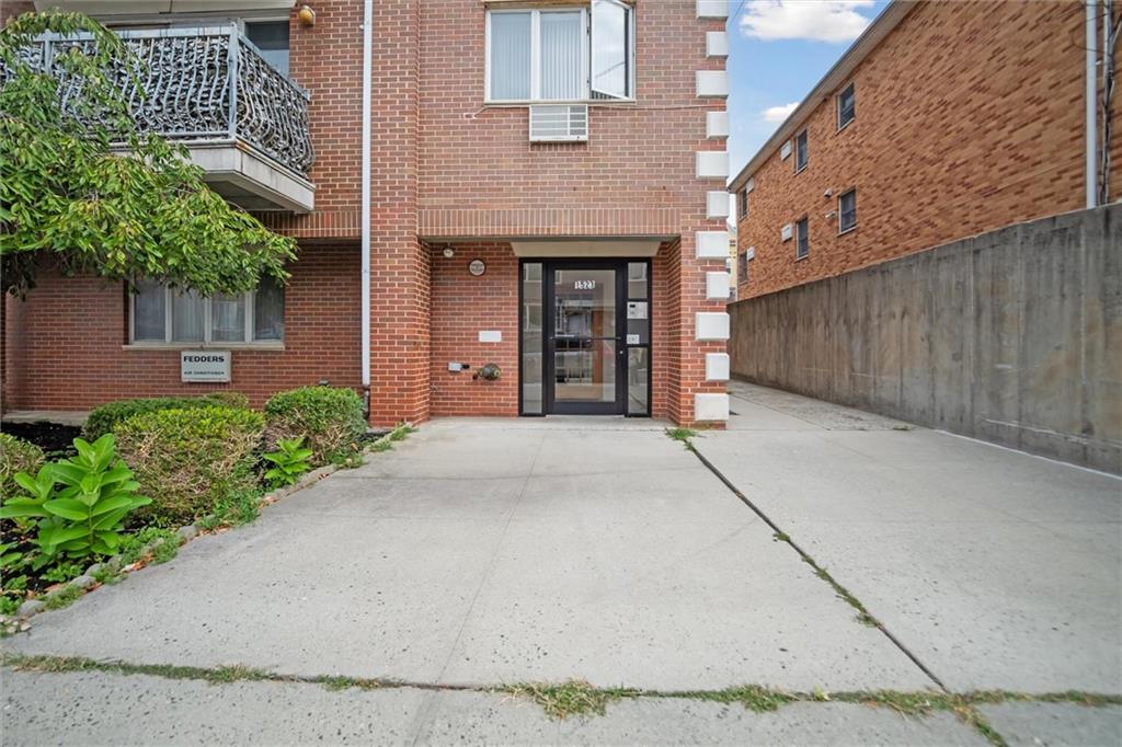 1523 74th Street, Unit 3F Brooklyn, NY 11228 - Photo 16 of 20 front view of a brick house with a yard
