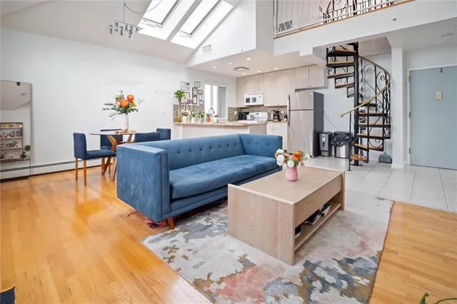 a living room with furniture and kitchen view