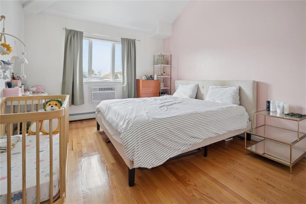 1523 74th Street, Unit 3F Brooklyn, NY 11228 - Photo 6 of 20 a bedroom with a bed and wooden floor