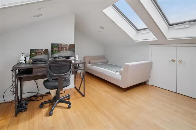 a view of a workspace with furniture and a window