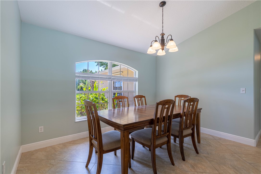 414 Ash Street Sebastian, FL 32958 - Photo 14 of 36 a dining room with furniture a chandelier and window