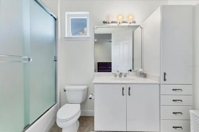 a bathroom with a sink a toilet and mirror
