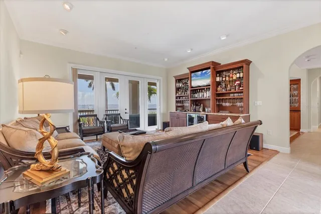 a living room with furniture a rug and a bookshelf