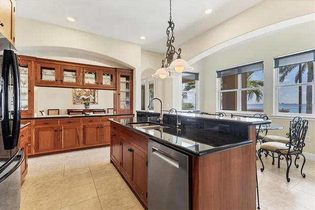 a kitchen with granite countertop a sink and stove