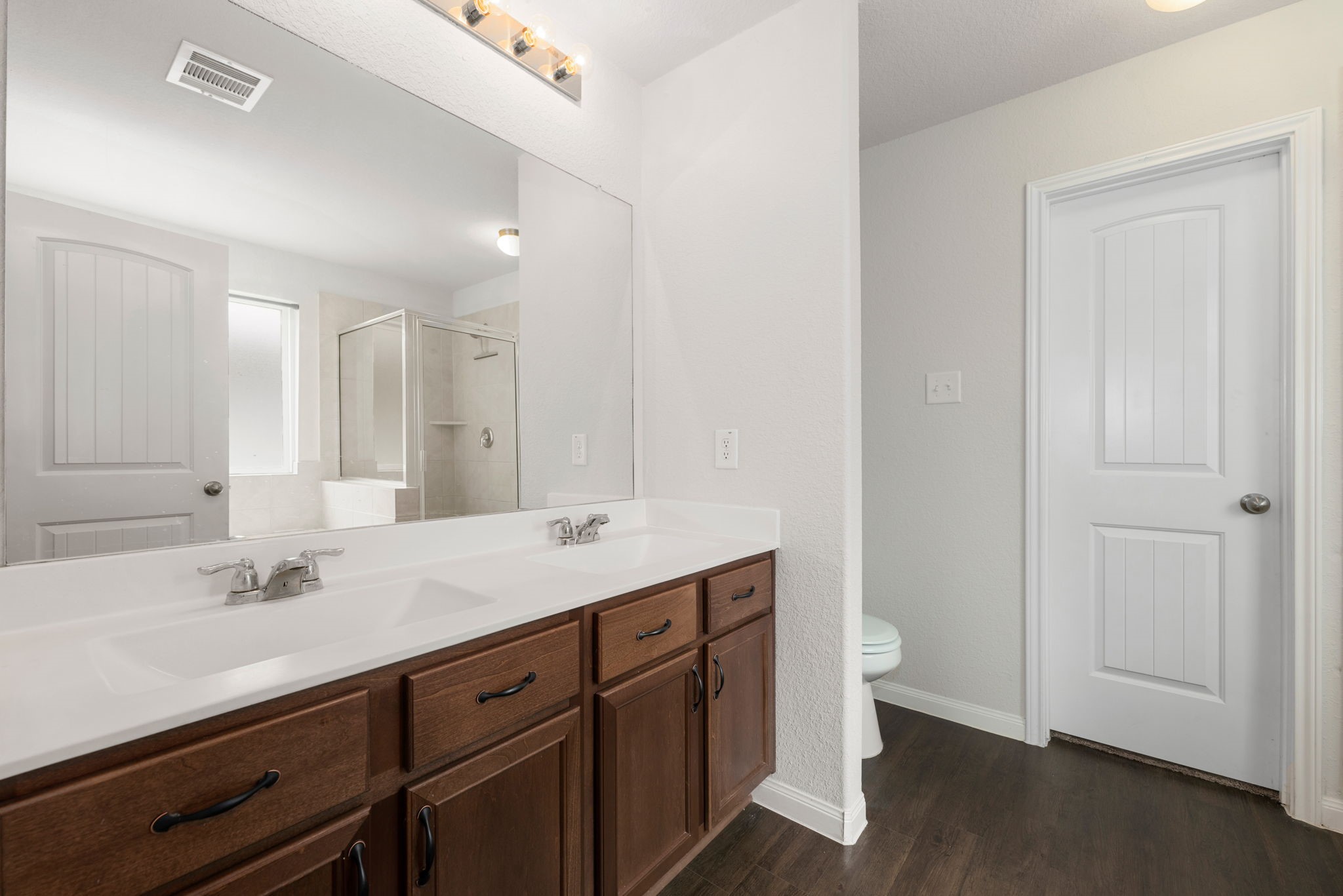 17555 Greystanes Road Humble, TX 77346 - Photo 15 of 28 a spacious bathroom with a double vanity sink and a mirror