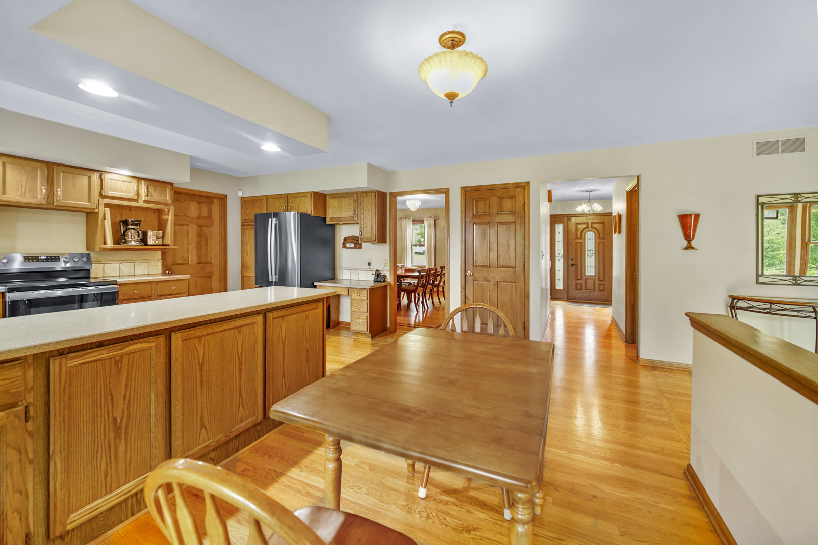 6 Red Hawk Drive Oswego, IL 60543 - Photo 9 of 41 a large kitchen with stainless steel appliances wooden floor a stove and a sink