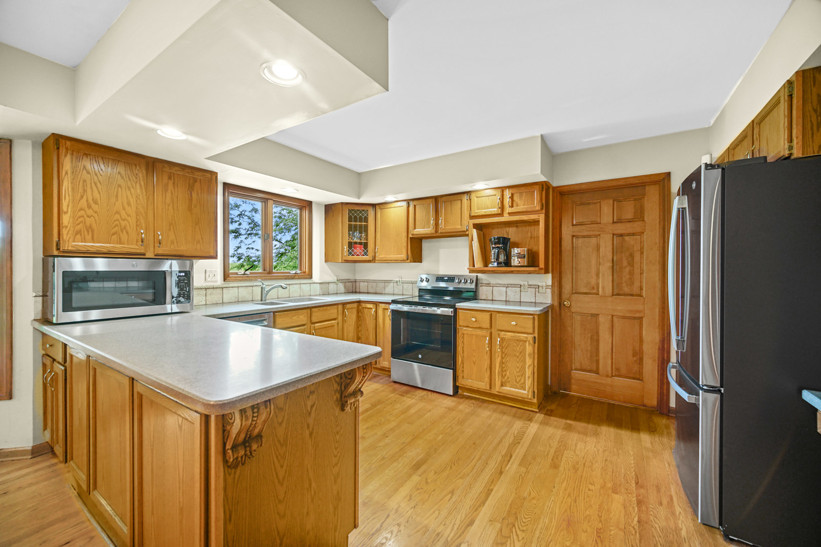 6 Red Hawk Drive Oswego, IL 60543 - Photo 10 of 41 a kitchen with stainless steel appliances granite countertop a refrigerator a sink dishwasher and a stove with wooden cabinets