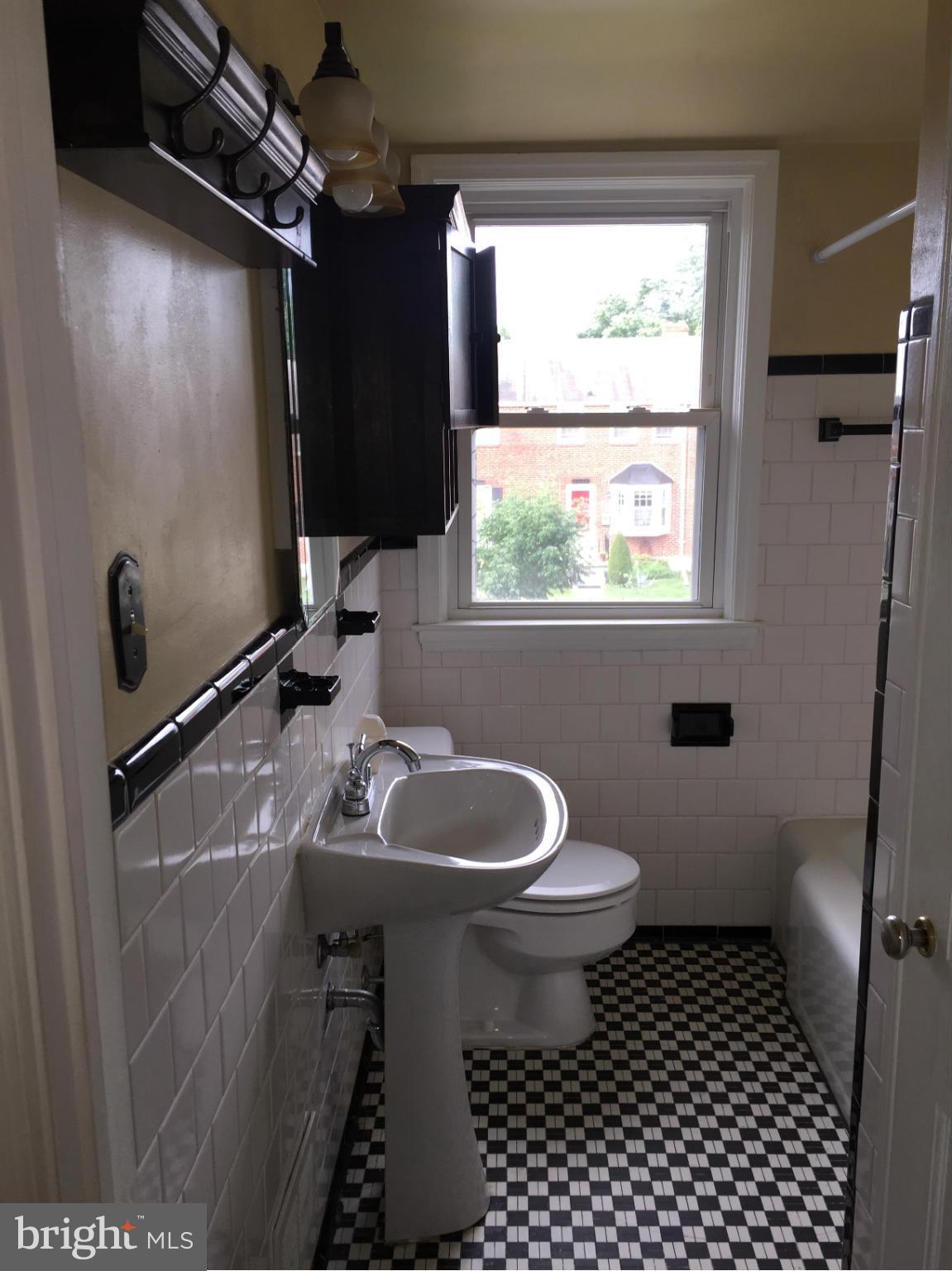1616 Thetford Road Towson, MD 21286 - Photo 11 of 13 a bathroom with a sink toilet a window and shower