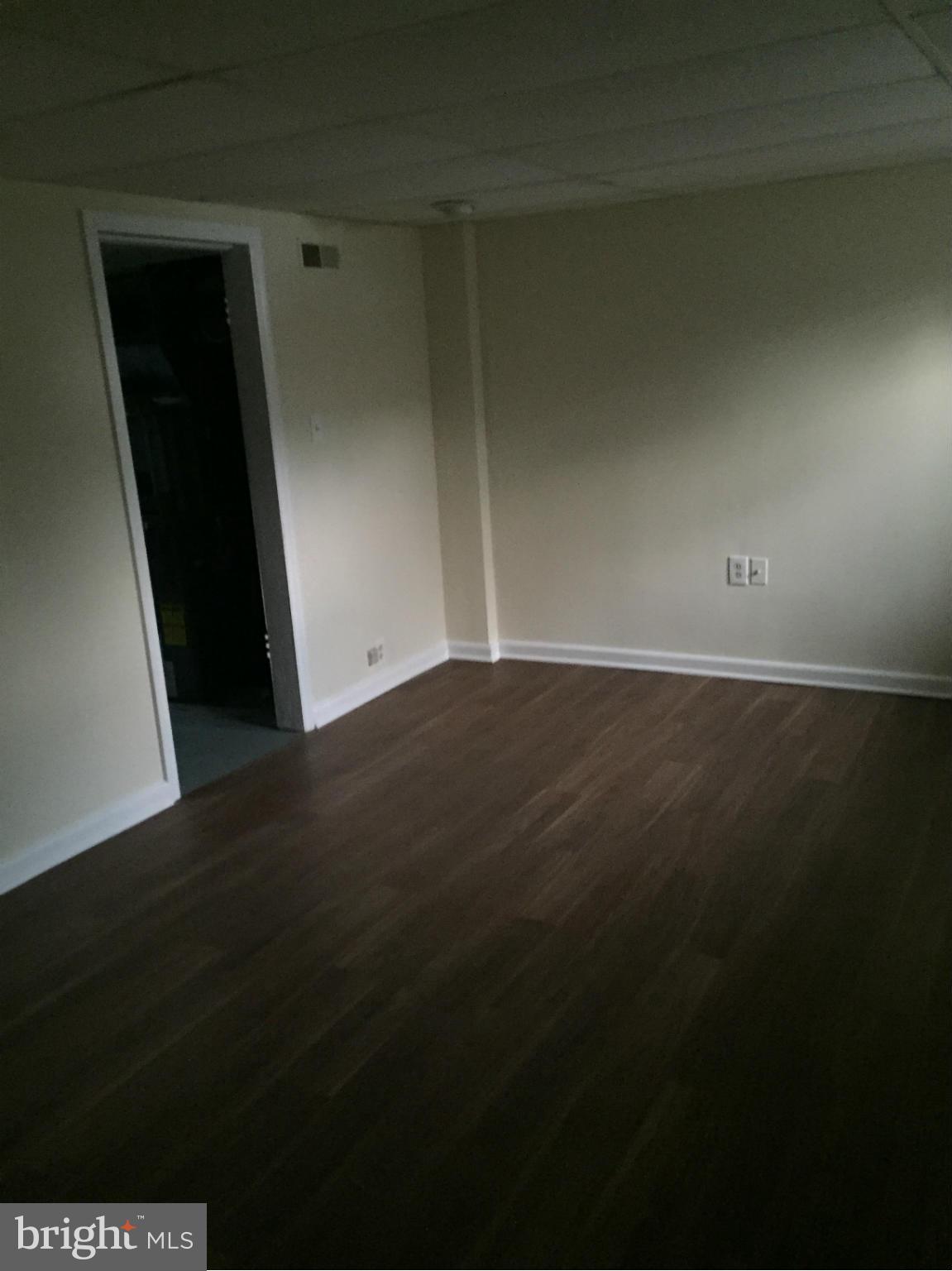 1616 Thetford Road Towson, MD 21286 - Photo 3 of 13 a view of an empty room and wooden floor