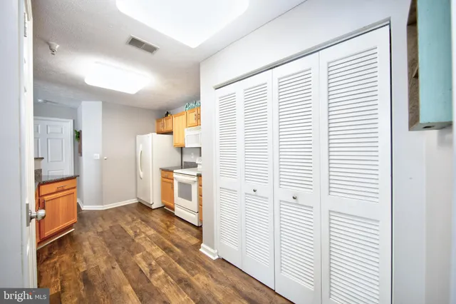 a view of a kitchen from the hallway