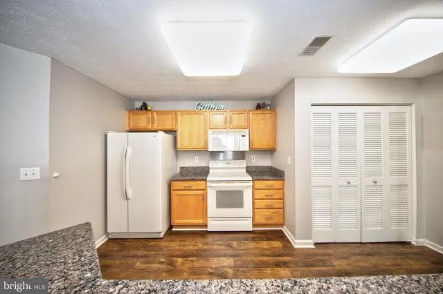 a view of a kitchen with refrigerator and dishwasher