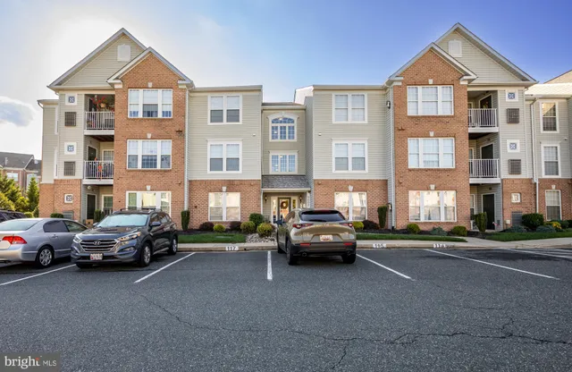 a car parked in front of a big room with large windows