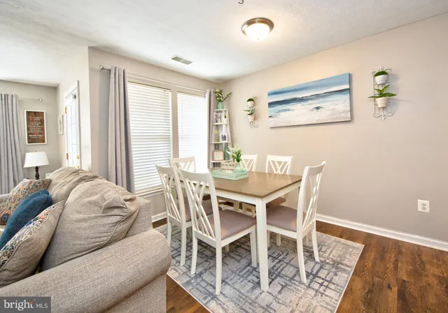a dining room with furniture and wooden floor