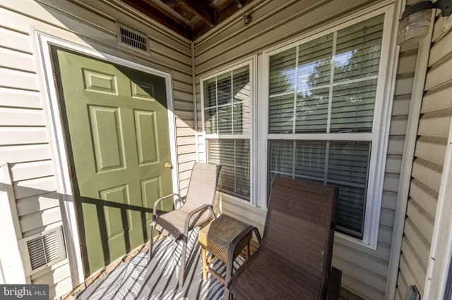a view of deck with chair and wooden floor