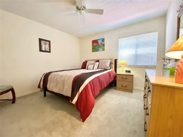 a bedroom with a bed dresser and a window