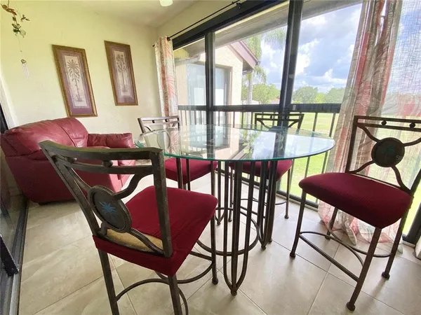 a view of a dining room with furniture a rug and wooden floor