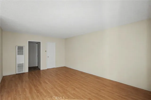 a view of an empty room and wooden floor