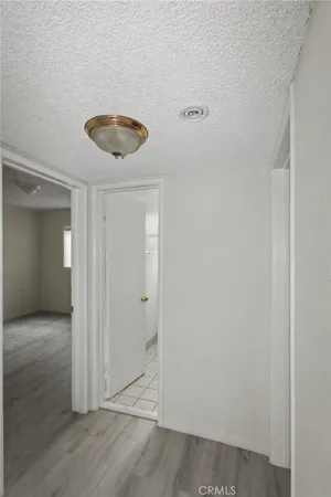 a view of a room with wooden floor and white doors