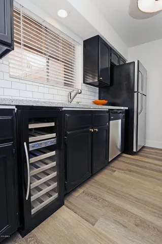 a kitchen with stainless steel appliances granite countertop a refrigerator and a stove top oven