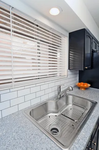 a kitchen with a sink and a window