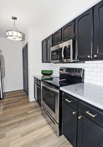 a kitchen with a sink stove and microwave