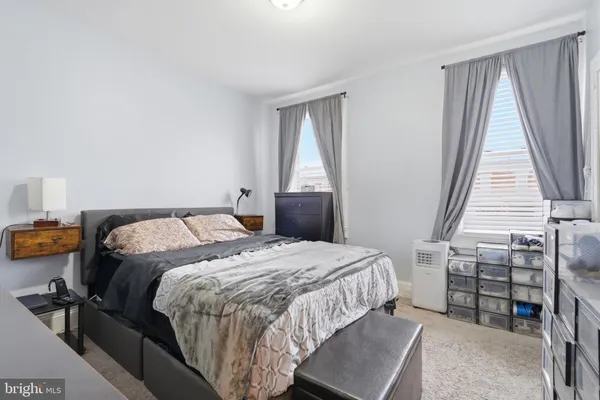 a bedroom with a bed and a dresser