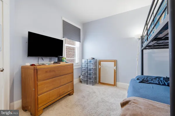 a bedroom with a bed and a table in it