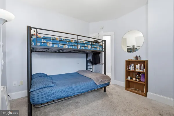a bedroom with a bed and a television