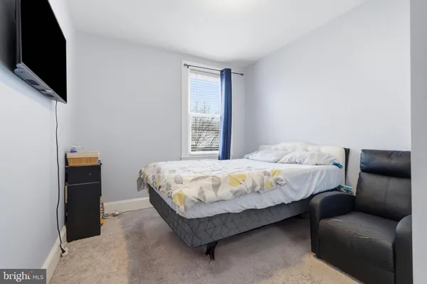 a bedroom with a bed and a mirror
