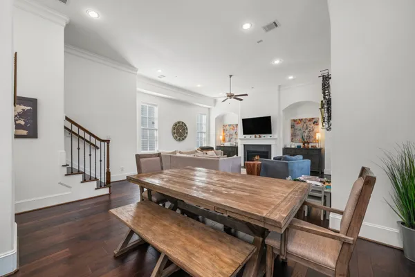 a dining room with furniture and wooden floor