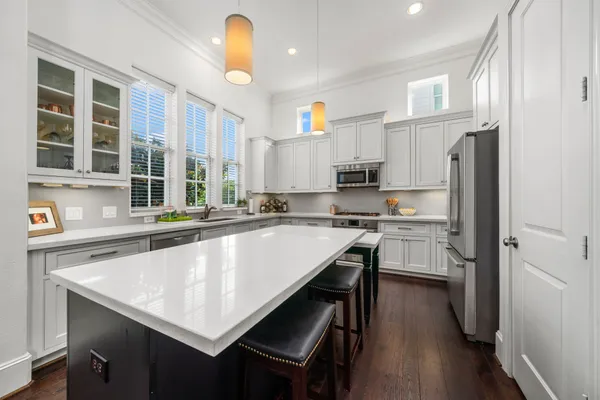a kitchen with a table chairs refrigerator and microwave