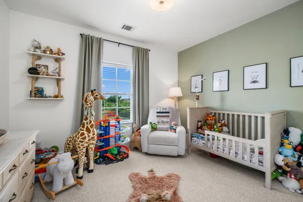 a children room with furniture and a couch