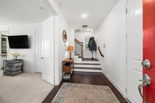 a view of a livingroom with furniture and an entryway