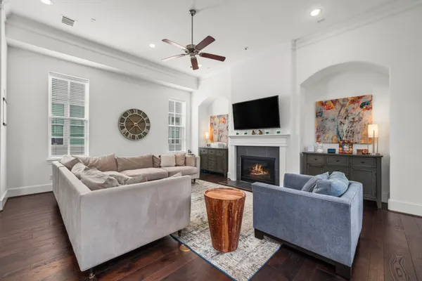 a living room with furniture a fireplace and a flat screen tv