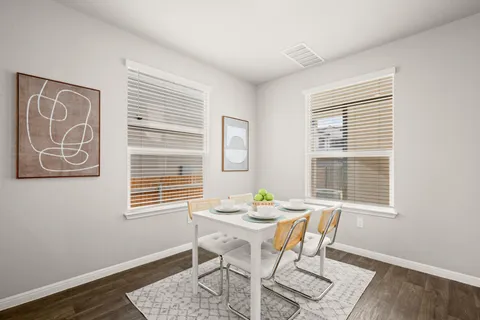 a view of a dining room with furniture and window