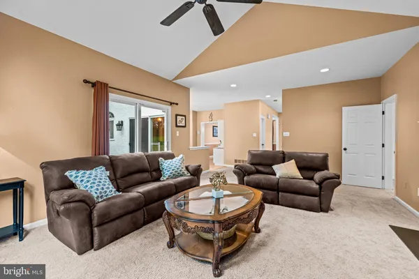 a dining room with furniture a chandelier and wooden floor