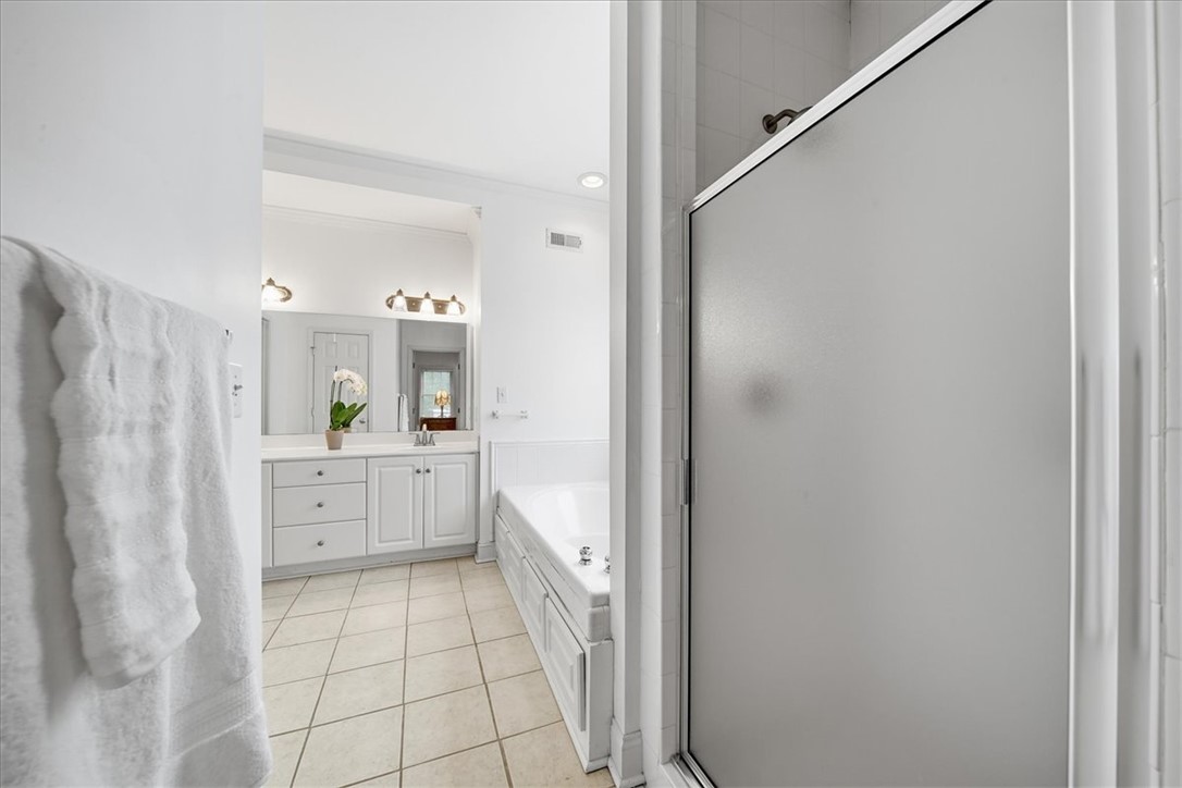 112 Elliott Circle Anderson, SC 29621 - Photo 25 of 35 A well-lit bathroom features a spacious vanity with ample storage and a walk-in shower.