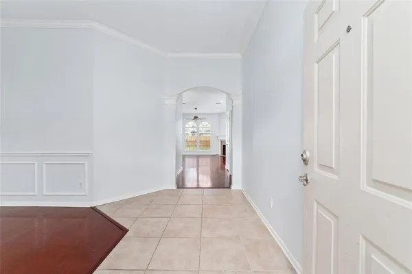 a view of a hallway with wooden floor and cabinet