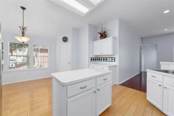 a kitchen that has a lot of cabinets in it