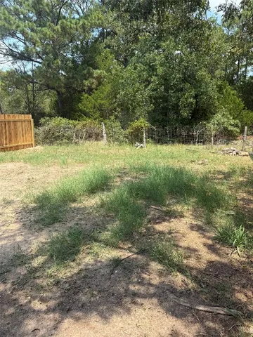 a view of a yard with a tree