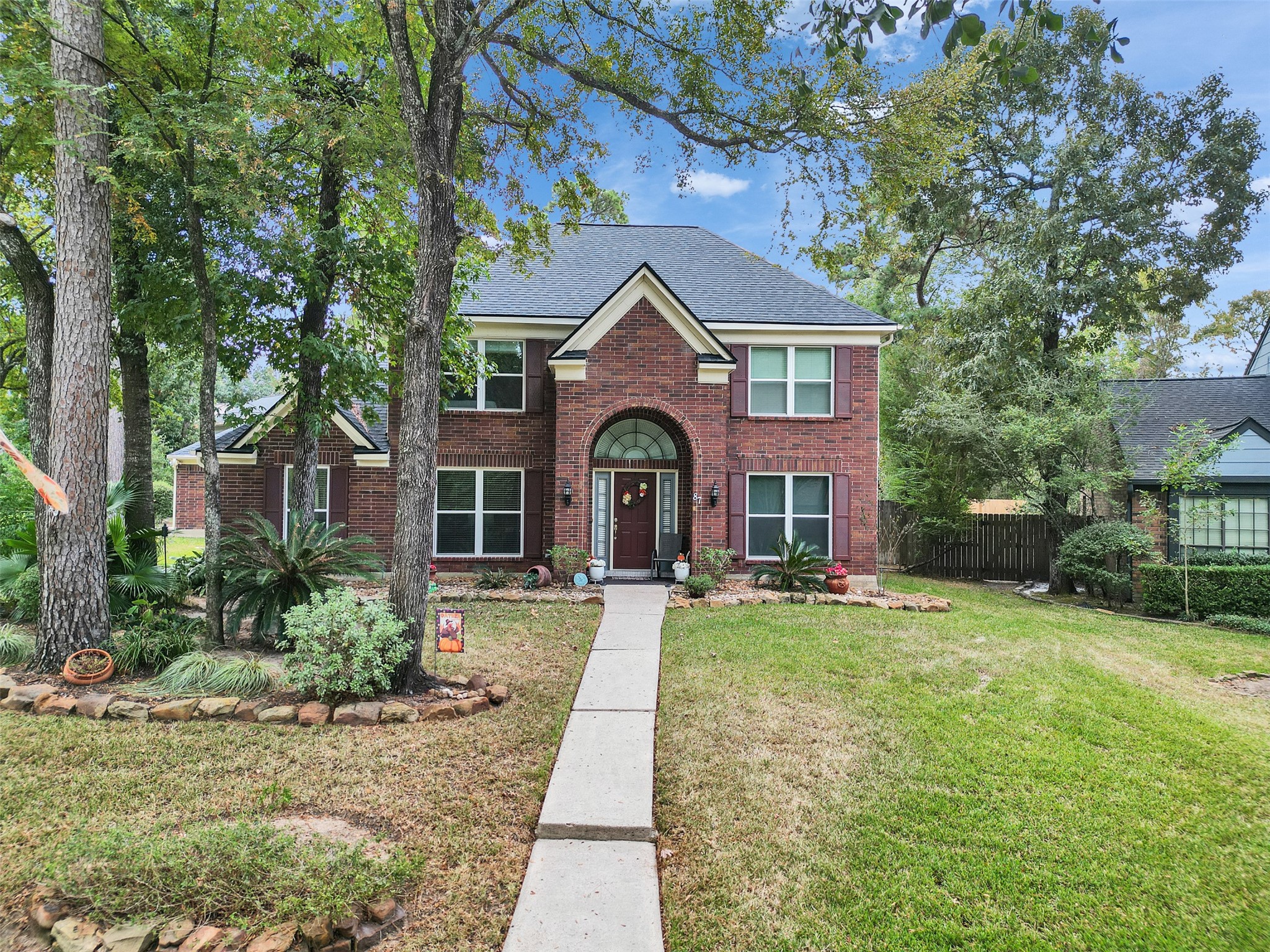 Elegant brick facade with pristine landscaping and timeless curb appeal.