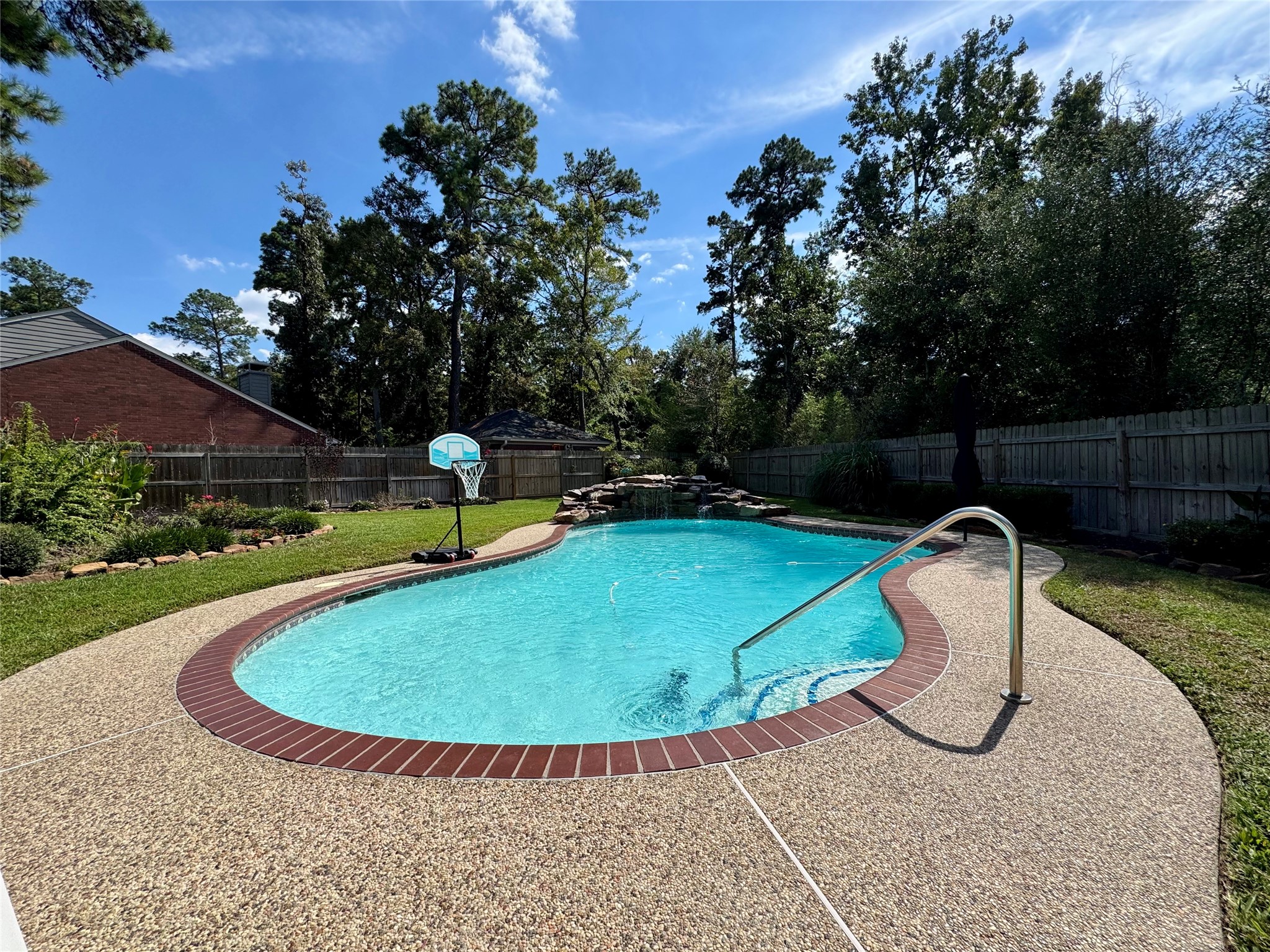 87 South Copper Sage Circle Spring, TX 77381 - Photo 22 of 28 backyard features a spacious, in-ground sparkling swimming pool surrounded by a clean pebble stone deck.