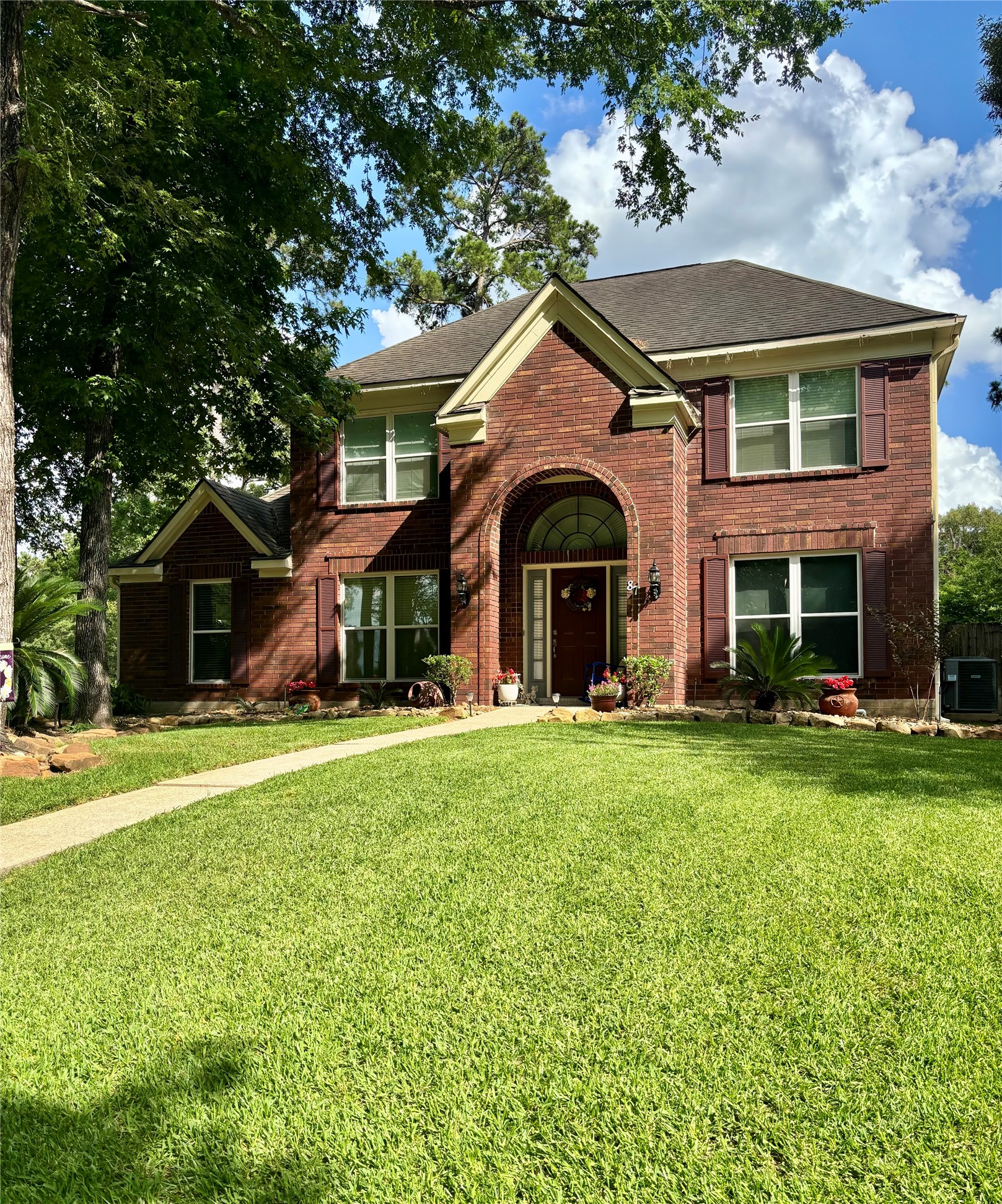 87 South Copper Sage Circle Spring, TX 77381 - Photo 3 of 28 Georgian-inspired traditional brick home with refined architectural symmetry, elegant entryway and mature landscaping.