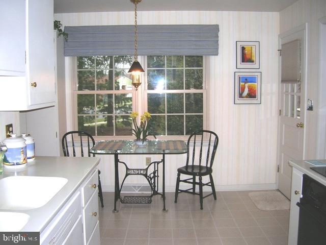 505 Bluebird Road Lititz, PA 17543 - Photo 8 of 14 a dining room with furniture a floor to ceiling window and a chandelier