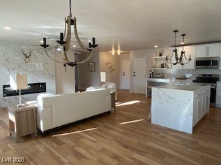 2712 Rialto Road Las Vegas, NV 89108 - Photo 16 of 54 Living room with a chandelier and wood finished floors