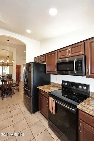 a kitchen with stainless steel appliances granite countertop a stove and a refrigerator