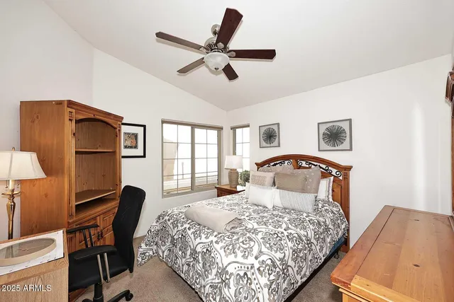 a bedroom with a bed a desk and chair