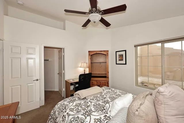 a bedroom with a bed and a dresser