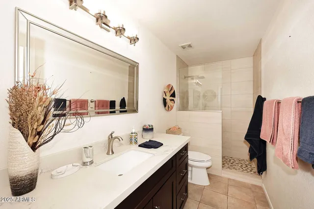 a bathroom with a sink toilet and mirror