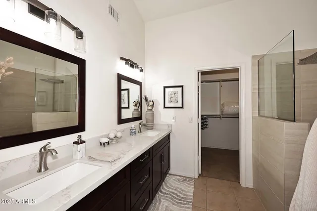 a bathroom with double vanity sinks and a mirror